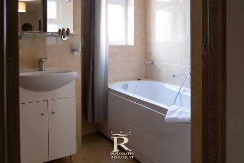 a bathroom with a bath tub and a sink at Apartament Modern Rivulus 28 in Baia Mare