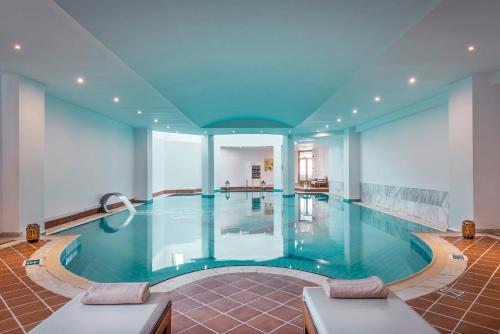 a pool in a building with a swimming pool at Mitsis Rodos Maris in Kiotari