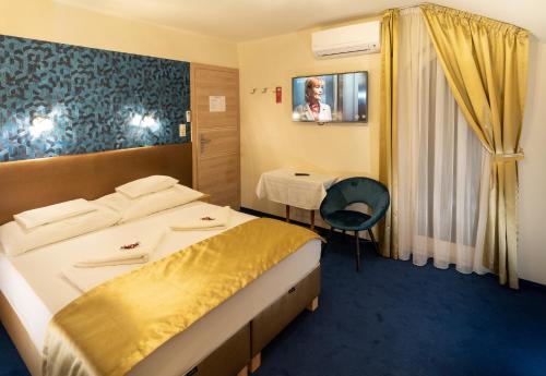 a hotel room with a bed and a table at Teátrum Boutique Hotel in Győr