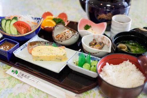 a tray of food with rice and other foods at Kibi Kogen Resort Hotel in Kaga
