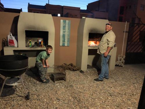 two men standing in front of a fire oven at Crayfish Creek in Langstrand