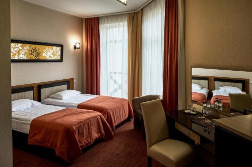 Säng eller sängar i ett rum på Optima Collection Park Hotel Ivano-Frankivsk