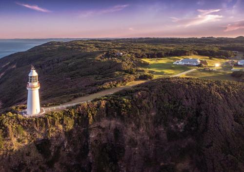 an aerial view of a lighthouse on a cliff at Cape Otway Lightstation in Cape Otway