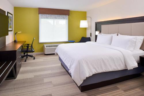 a hotel room with a large bed and a desk at Holiday Inn Express & Suites - Shreveport - Downtown by IHG in Shreveport