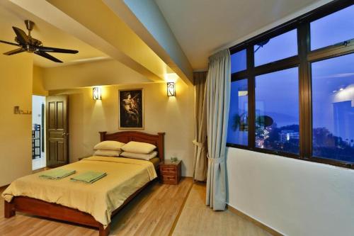 Katil atau katil-katil dalam bilik di Susie's Resort Seaview Suites at Sri Sayang