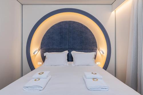 a bedroom with a large bed with two white towels at Onira Suite Dreams in Hersonissos