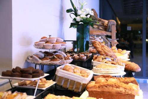 a display of different types of pastries and pies at Kenzi Rose Garden in Marrakech