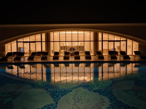 a group of chairs sitting in a pool in a building at Miyakojima Kurima Resort Seawood Hotel in Miyako Island