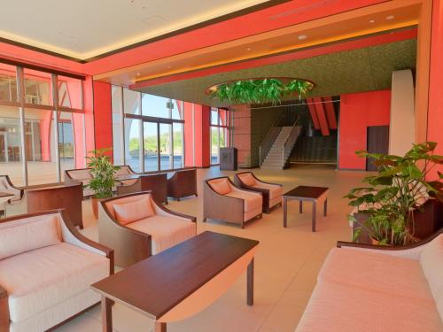 a lobby with chairs and tables in a building at Miyakojima Kurima Resort Seawood Hotel in Miyako Island