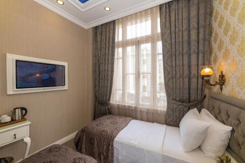 a hotel room with a bed and a window at Alpek Hotel in Istanbul