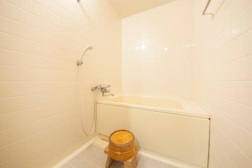 a white bathroom with a toilet and a sink at Nishiizu Koyoi in Numazu