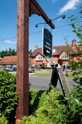 a sign on a pole next to a street at Dog House by Chef & Brewer Collection in Abingdon