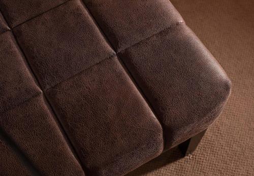 a close up of a brown leather couch at Hotel Kernen in Gstaad