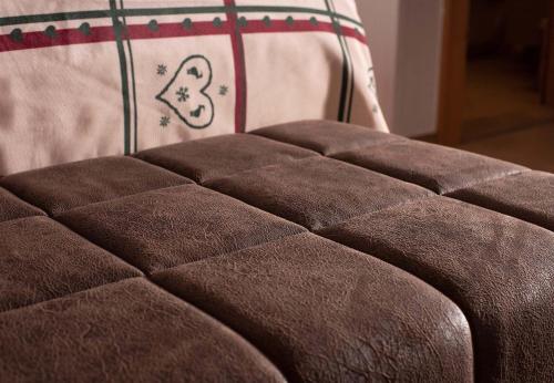 a close up of the back of a brown couch at Hotel Kernen in Gstaad