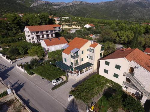 an aerial view of a town with houses and a street at Apartments Maestral in Orebić