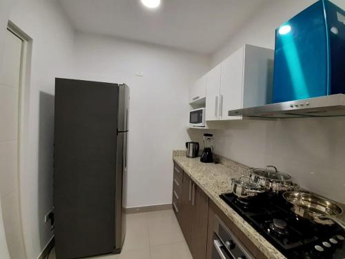 a kitchen with a refrigerator and a counter top at DPTO Ejecutivo en PIURA 1 HAB in Piura