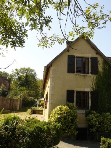 a white house with black shutters on it at CHATEAU DE LACOMTE COUNTRY CLUB in Carlucet