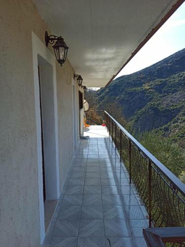 a balcony of a building with a view of a mountain at Awesomnest in Dhimitsana