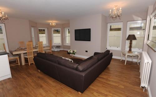 a living room with a couch and a dining room at Tower Apartments in Southend-on-Sea