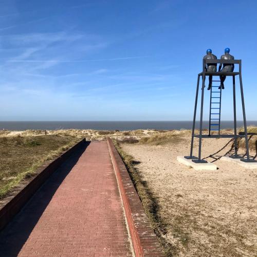 two people sitting on a lookout tower on the beach at Sea and Dunes in Knokke-Heist