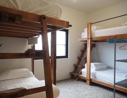 a room with two bunk beds and a window at H. 1967 in Changhua City