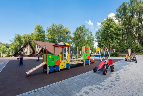 a playground with children playing on playground equipment at Reikartz Park Hotel Ivano-Frankivsk in Ivano-Frankivsk