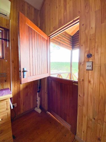 a bathroom with a toilet in a room with a window at Yorkdale Cabin in Sabie