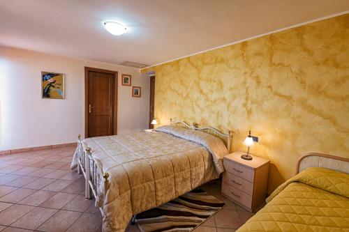 a bedroom with two beds and a table and a lamp at B&B Matilde in Mormanno