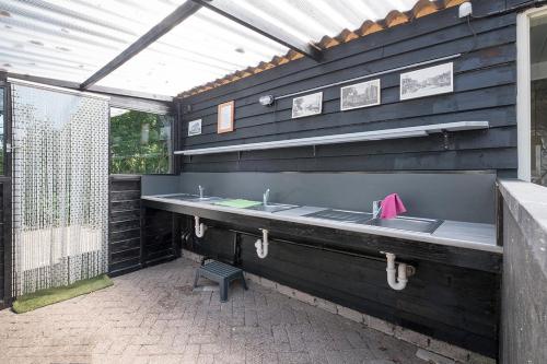 a outdoor bathroom with two sinks and a shower at Safaritent de Berghoeve in Ruinen