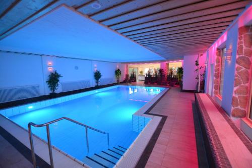 a swimming pool in a hotel with lights on at Wellness Hotel Garni Krone in Baiersbronn