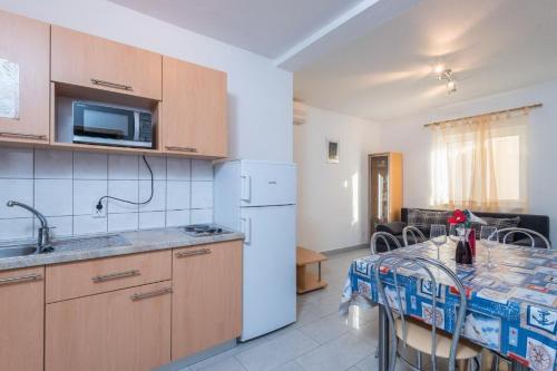 a kitchen with a table and a counter top at Apartments Maestral in Orebić