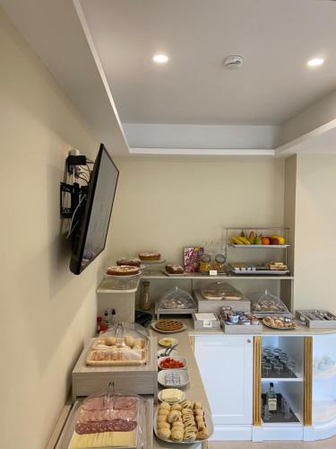 a room with a counter with different types of food at Grand Hotel Royal in Pompei