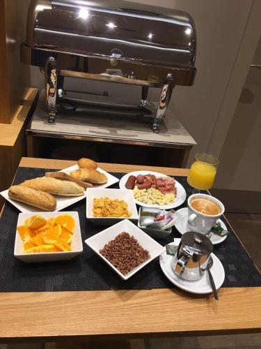 a table with many plates of food on it at Hostal Anton Martin in Madrid