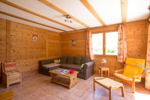 a living room with a couch and a table at L'Echaillon - Soldanelle in Névache