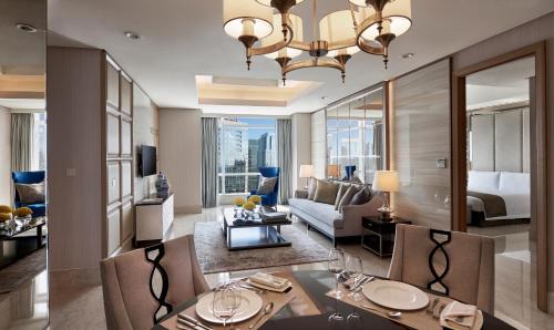 a living room with a couch and a dining room at The Residences of The Ritz-Carlton Jakarta Pacific Place in Jakarta