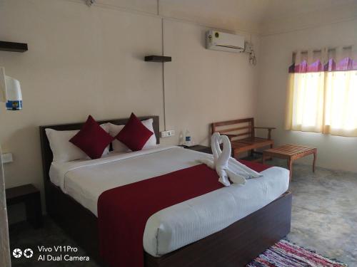 a bedroom with a bed with a stuffed animal on it at Havelock Farms Resort in Havelock Island