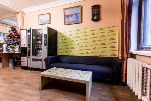 a living room with a couch and a coffee table at Все Сезоны / All Seasons in Saint Petersburg