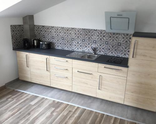 a kitchen with wooden cabinets and a sink at Apartment No. 121 in Rottweil