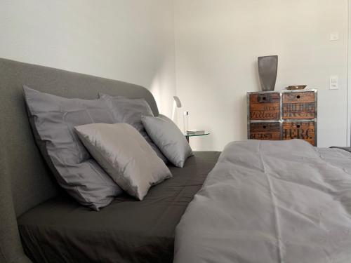 a bed with white pillows on it in a bedroom at Central & Elegant Room in Biel in Biel