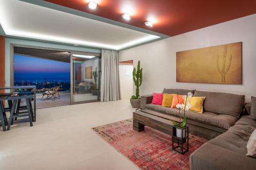 a living room with a couch and a table at Onira Suite Dreams in Hersonissos