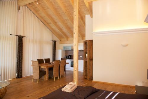 a living room with a table and a dining room at Landhaus Kössel in Füssen