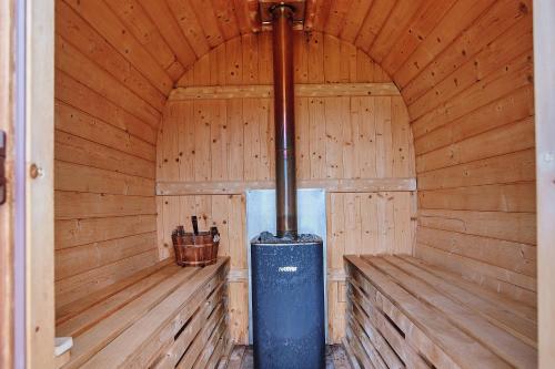 an inside of a wooden cabin with a stove at Gospodarstwo Agroturystyczne Antoniewo in Antoniewo