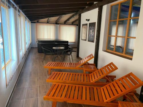 a corridor with benches and a piano in a room at Penzion Rejviz in Rejvíz