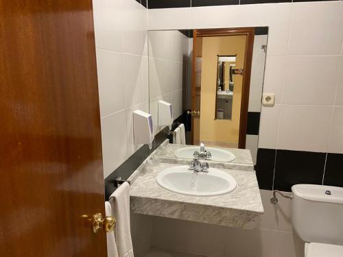 a bathroom with a sink and a toilet at Hotel La Parada in Ontígola