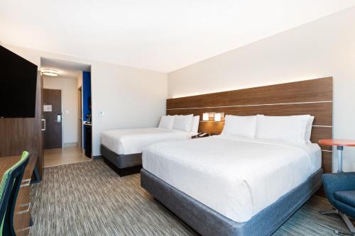 a hotel room with two beds and a flat screen tv at Holiday Inn Express & Suites Niceville - Eglin Area by IHG in Niceville