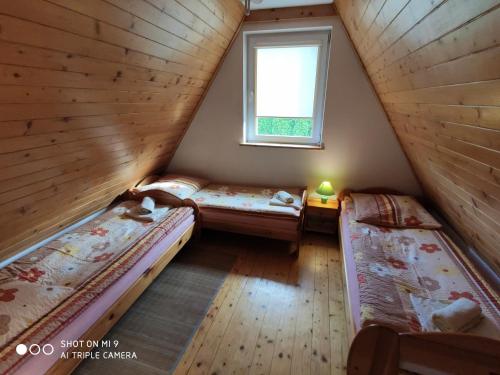a room with two beds and a window at Apartament-studio, pokoje u Lucy in Rabka-Zdrój