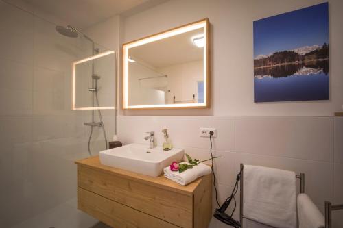 a bathroom with a sink and a mirror at Goasblick - by NV Appartements in Kirchberg in Tirol