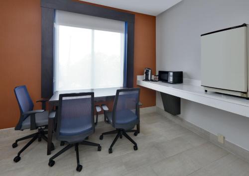 a conference room with a table and four chairs at Holiday Inn Express & Suites Dallas - Duncanville by IHG in Duncanville