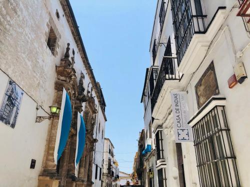 an alley with a building with blue signs on it at Art Suites by Casa de Indias in El Puerto de Santa María