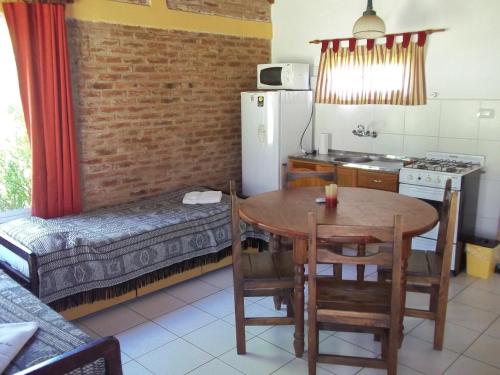 a kitchen with a table and a dining room at La Posada del Mar in Miramar